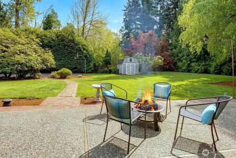 a view of a chairs and table on the garden
