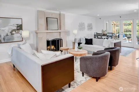 a living room with fireplace furniture and a wooden floor