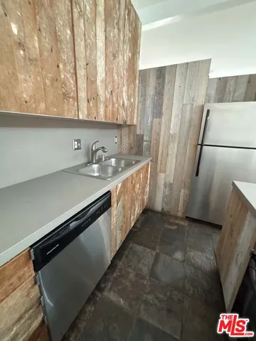 a kitchen with stainless steel appliances a refrigerator and a stove