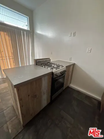 a kitchen with granite countertop a stove and a sink