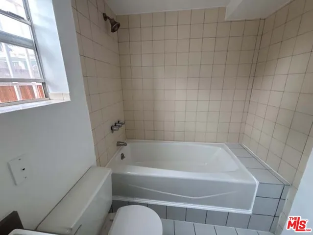 a bathroom with a bathtub and window