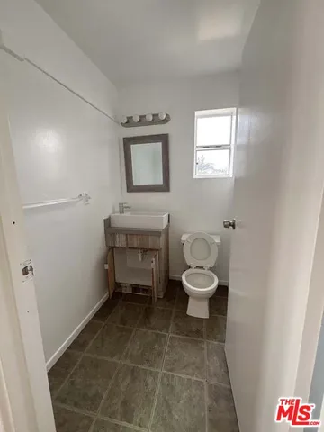 a bathroom with a toilet and a rug