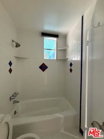 a bathroom with a bathtub and shower