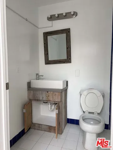 a bathroom with a toilet a sink and a mirror