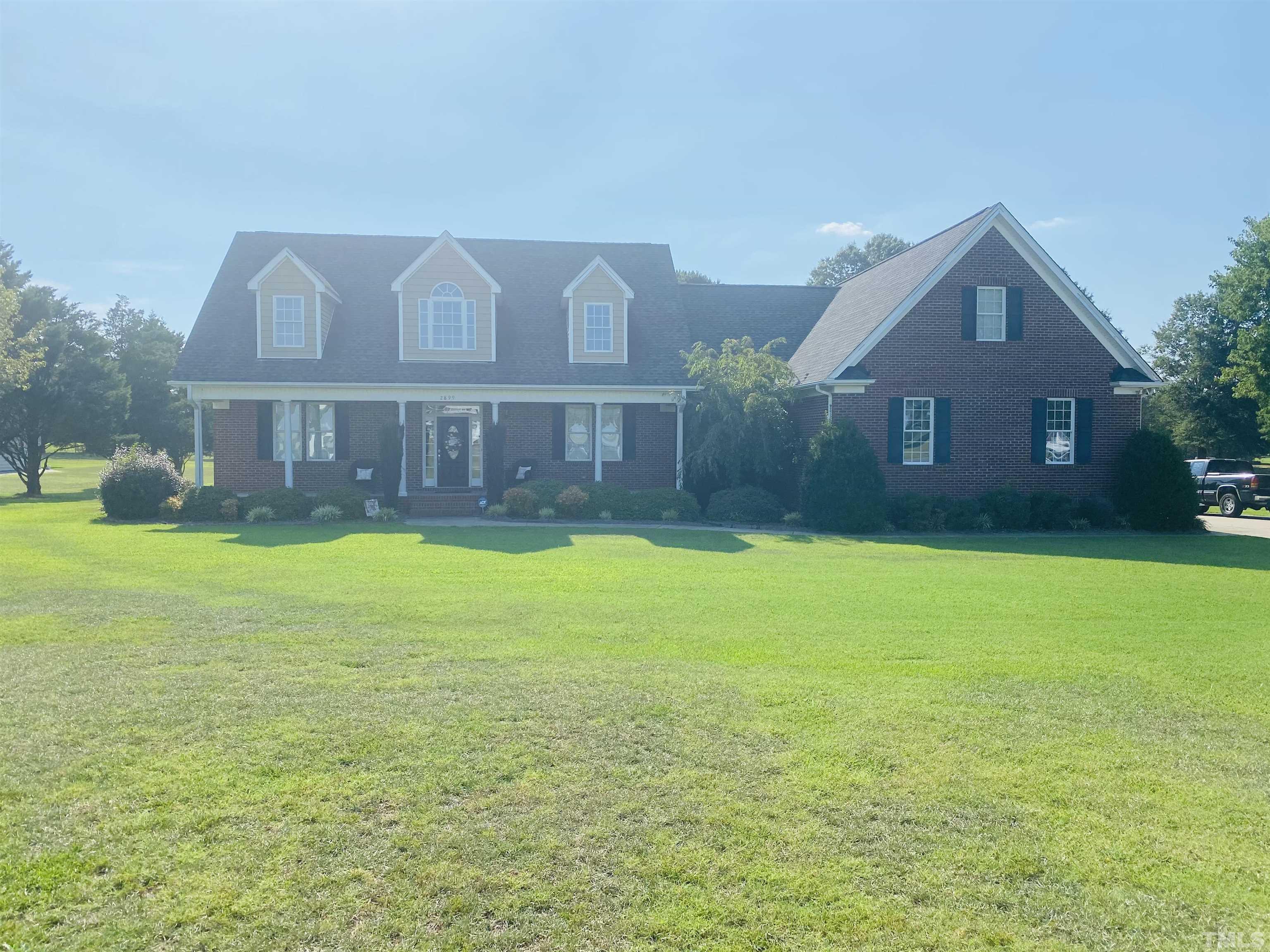 a view of a house next to a big yard