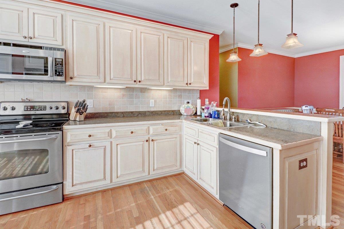 2899 Benson Hardee Road Benson, NC 27504 - Photo 13 of 31 a kitchen with stainless steel appliances granite countertop a stove a sink and a microwave