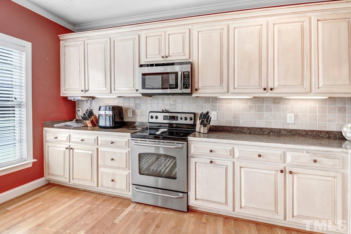 2899 Benson Hardee Road Benson, NC 27504 - Photo 14 of 31 a kitchen with stainless steel appliances granite countertop white cabinets granite counter tops and a window