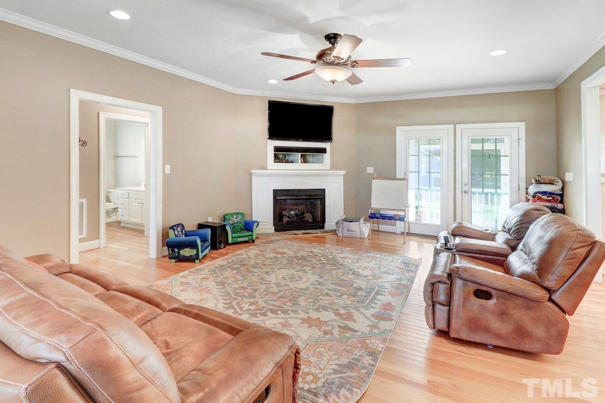 2899 Benson Hardee Road Benson, NC 27504 - Photo 20 of 31 a living room with furniture fireplace and flat screen tv