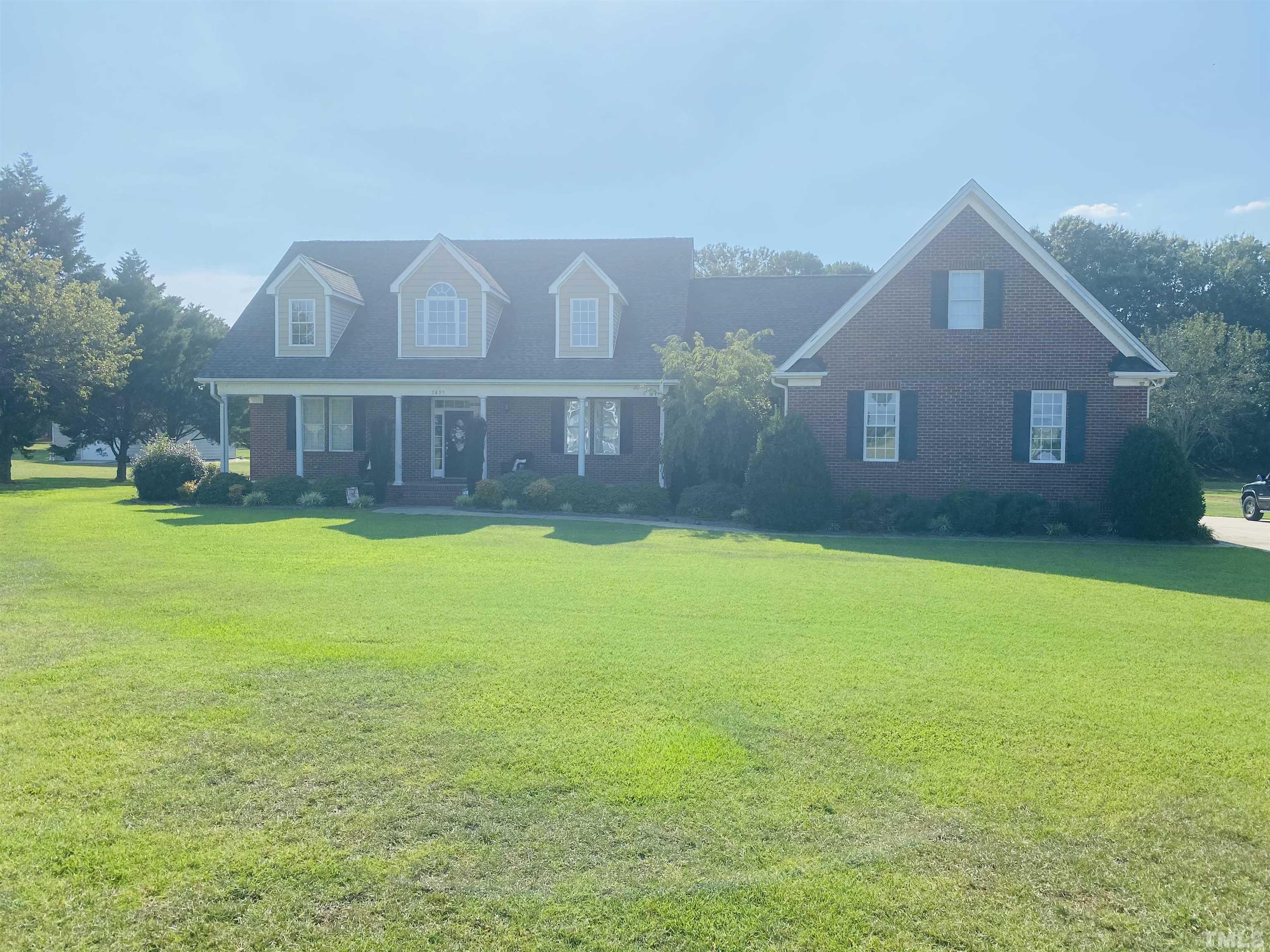 2899 Benson Hardee Road Benson, NC 27504 - Photo 2 of 31 a view of a big house with a big yard and palm trees