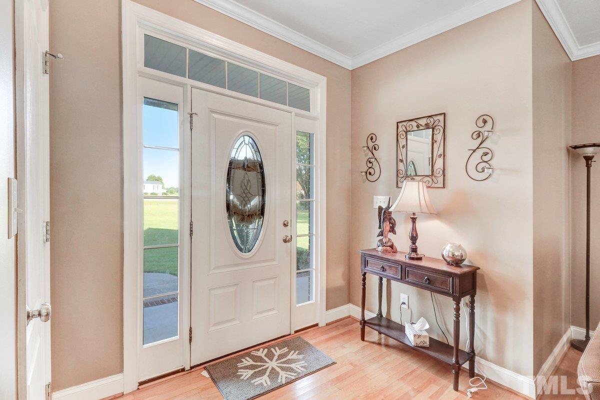2899 Benson Hardee Road Benson, NC 27504 - Photo 21 of 31 a view of a livingroom with wooden floor and a mirror