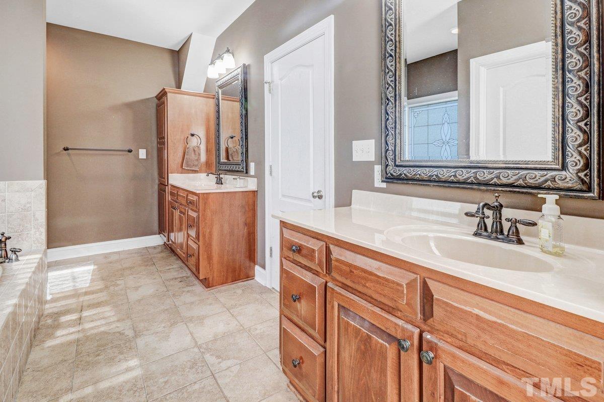 2899 Benson Hardee Road Benson, NC 27504 - Photo 3 of 31 a spacious bathroom with a sink double vanity and a mirror