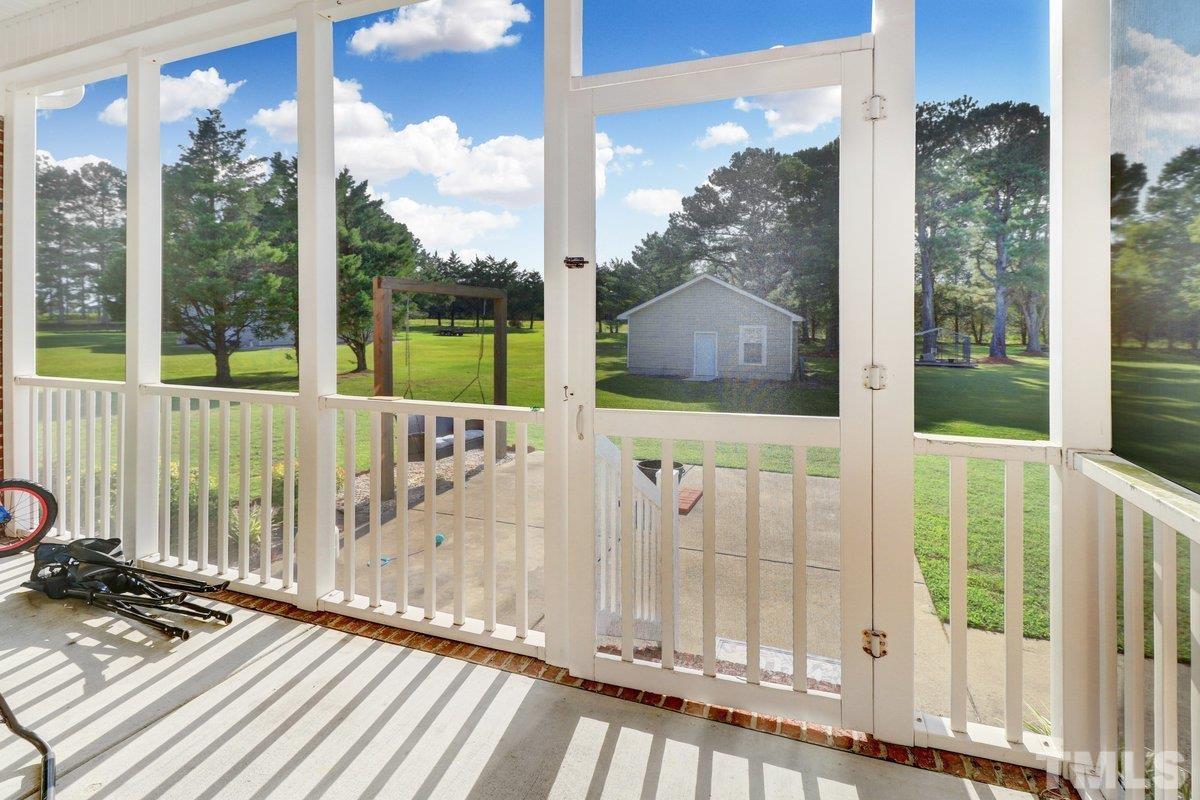 2899 Benson Hardee Road Benson, NC 27504 - Photo 31 of 31 a view of a balcony with a swing
