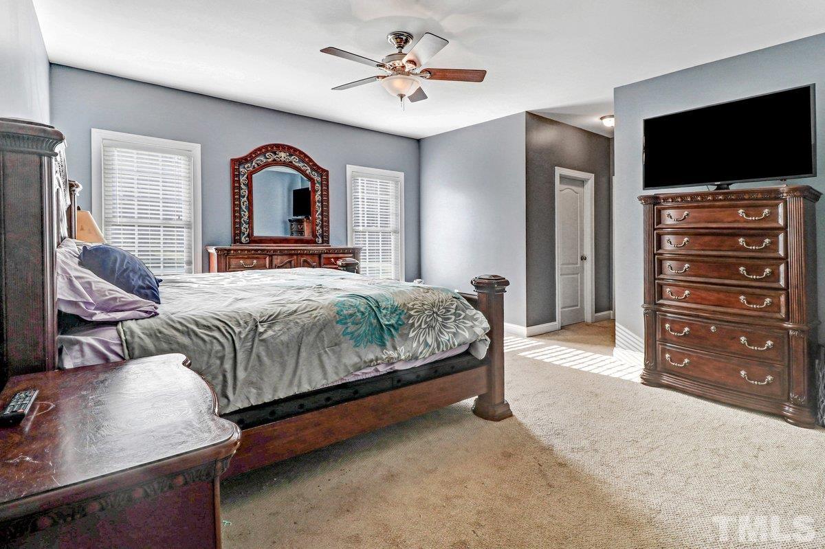 2899 Benson Hardee Road Benson, NC 27504 - Photo 5 of 31 a bedroom with a bed and a flat screen tv