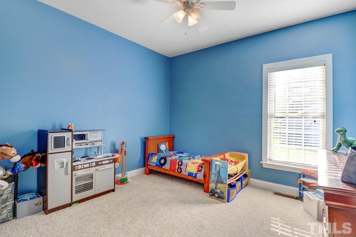 2899 Benson Hardee Road Benson, NC 27504 - Photo 7 of 31 a bedroom with bed and a window