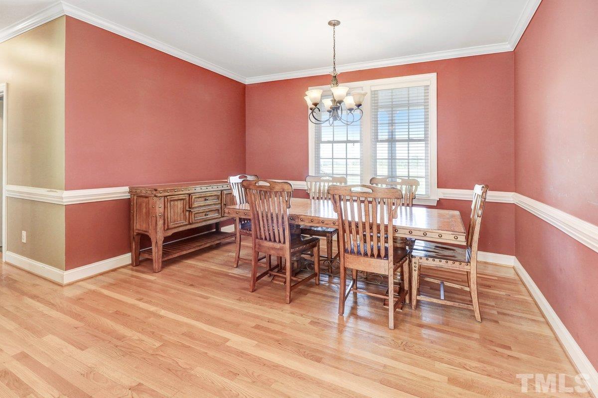 2899 Benson Hardee Road Benson, NC 27504 - Photo 10 of 31 a view of a dining room with furniture wooden floor and chandelier