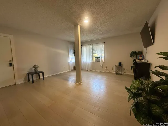a view of a livingroom with furniture and a flat screen tv