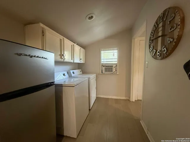 a kitchen with a refrigerator and a stove