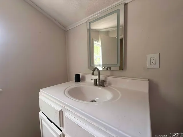 a bathroom with a sink and a mirror