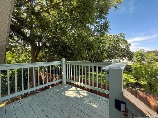 a balcony with wooden floor and outdoor space