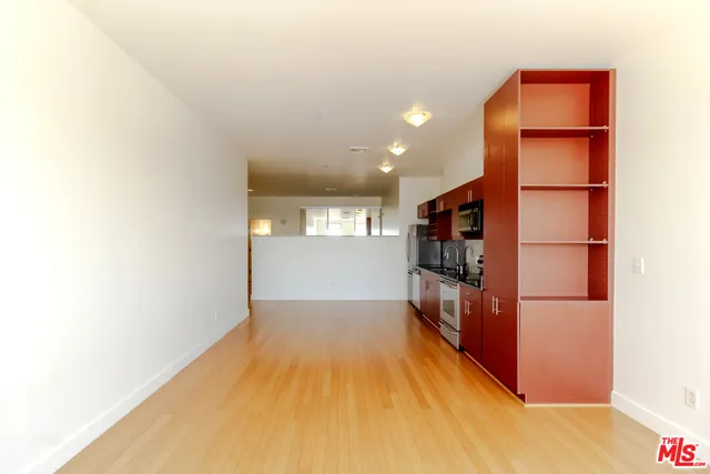 a bathroom with a granite countertop sink a toilet a mirror and shower