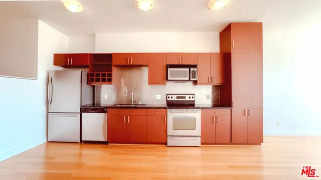 a view of a kitchen with wooden floor and a sink