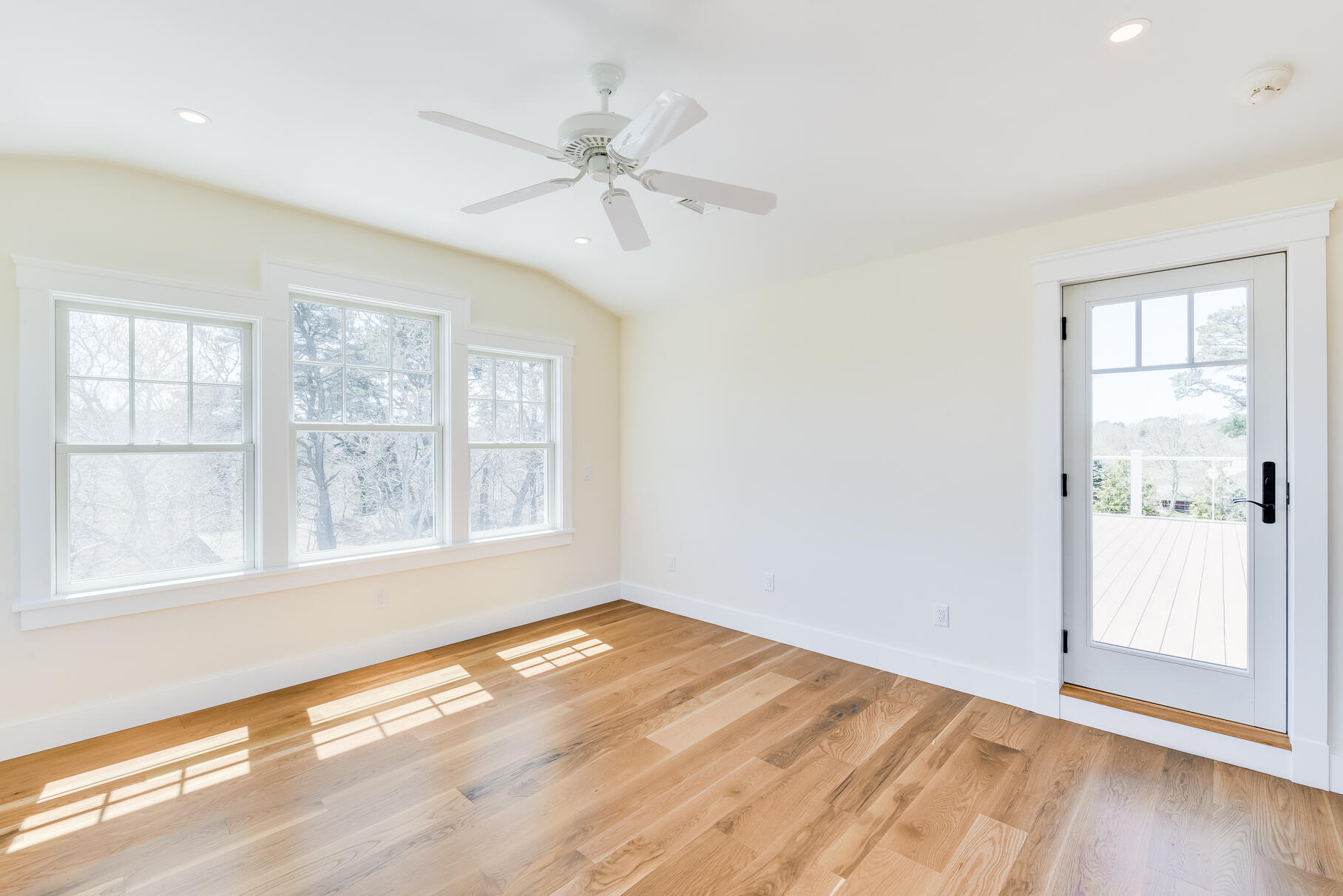 159 Sesuit Neck Road East Dennis, MA 02641 - Photo 44 of 78 an empty room with wooden floor fan and windows