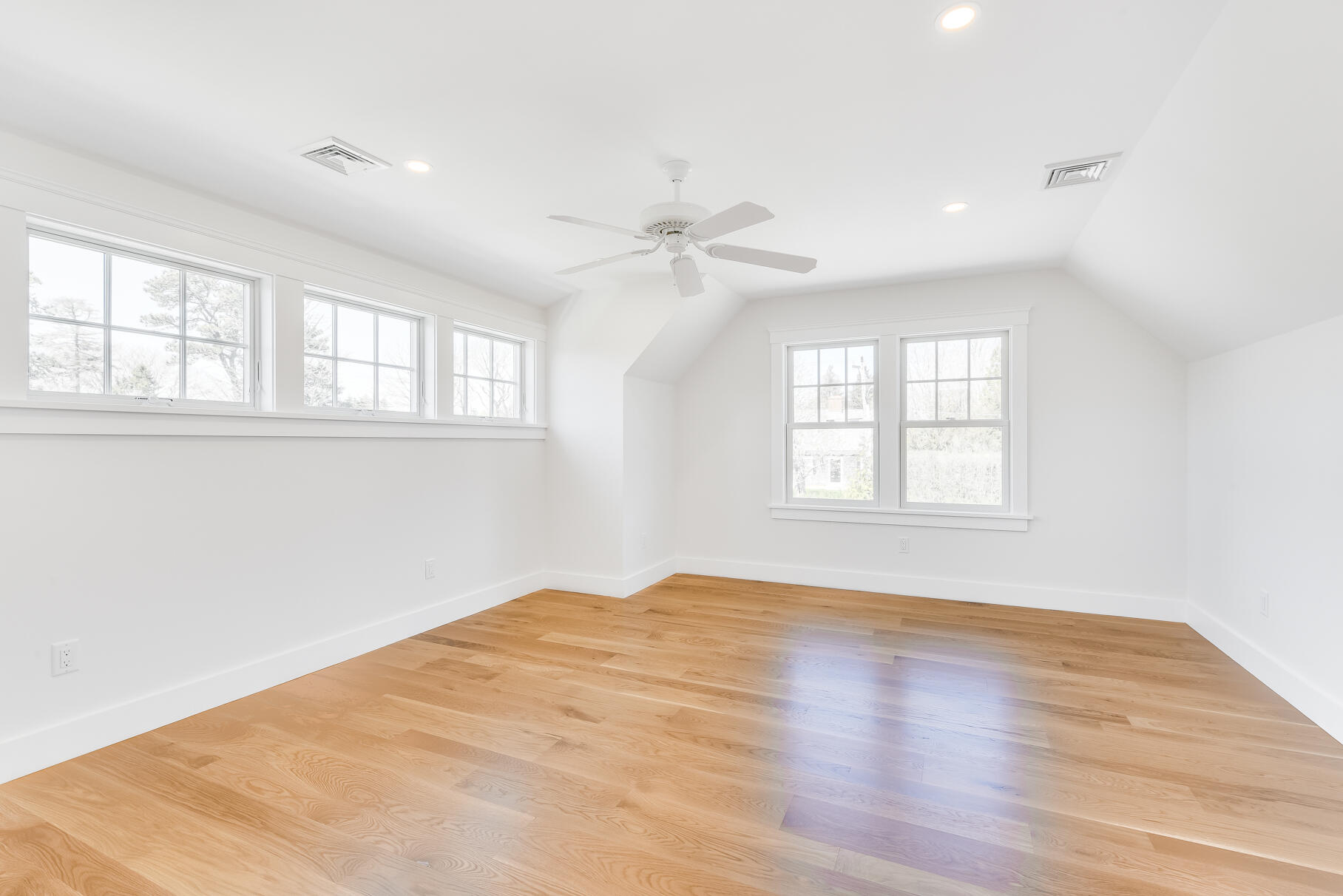 159 Sesuit Neck Road East Dennis, MA 02641 - Photo 50 of 78 an empty room with wooden floor and windows