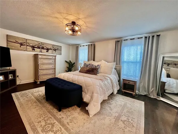 a bedroom with a bed and a chandelier