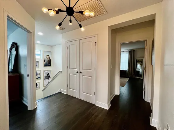a view of a hallway view with wooden floor and staircase