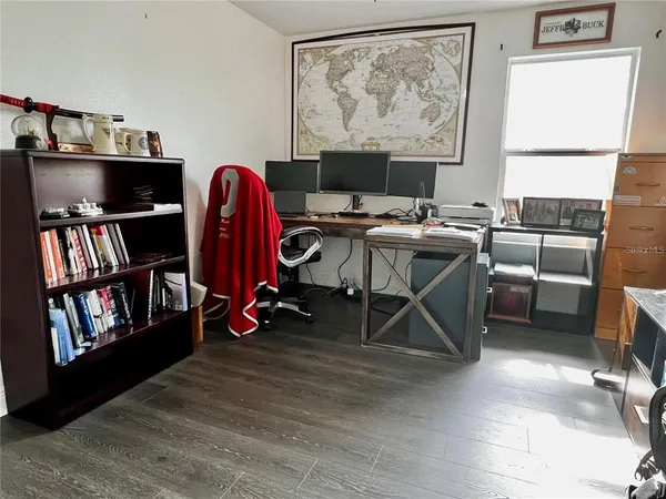 a view of a workspace with furniture and a living room