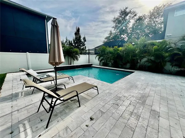 a backyard of a house with table and chairs