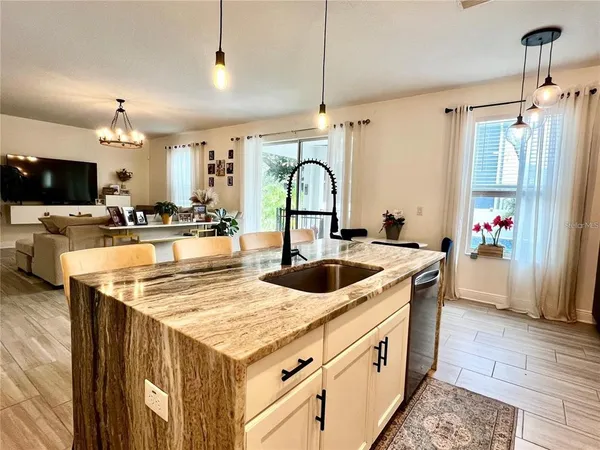 a kitchen with stainless steel appliances granite countertop a sink and a stove