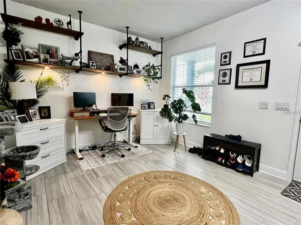 a living room with furniture and a chandelier