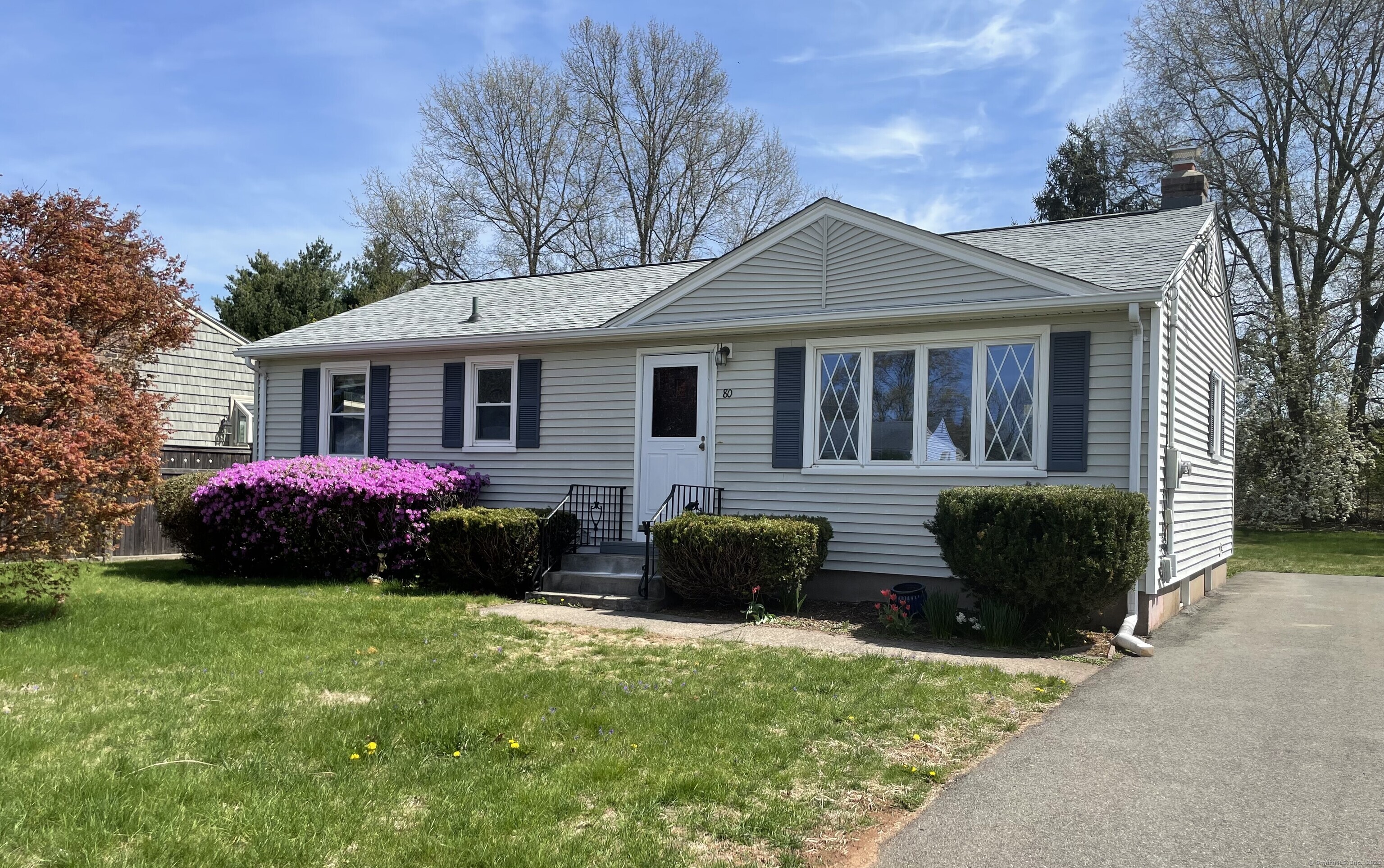 a front view of a house with a garden