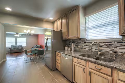 3523 Charleston Street Houston, TX 77021 - Photo 5 of 17 a kitchen with sink cabinets and wooden floor