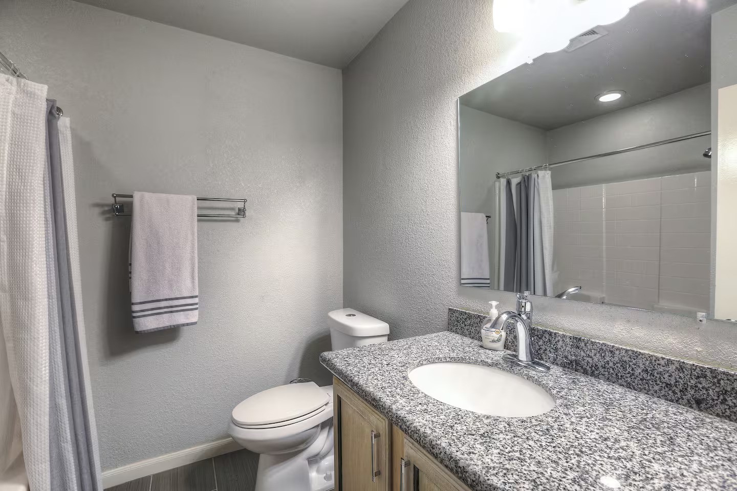 3523 Charleston Street Houston, TX 77021 - Photo 7 of 17 a bathroom with a granite countertop toilet sink and mirror