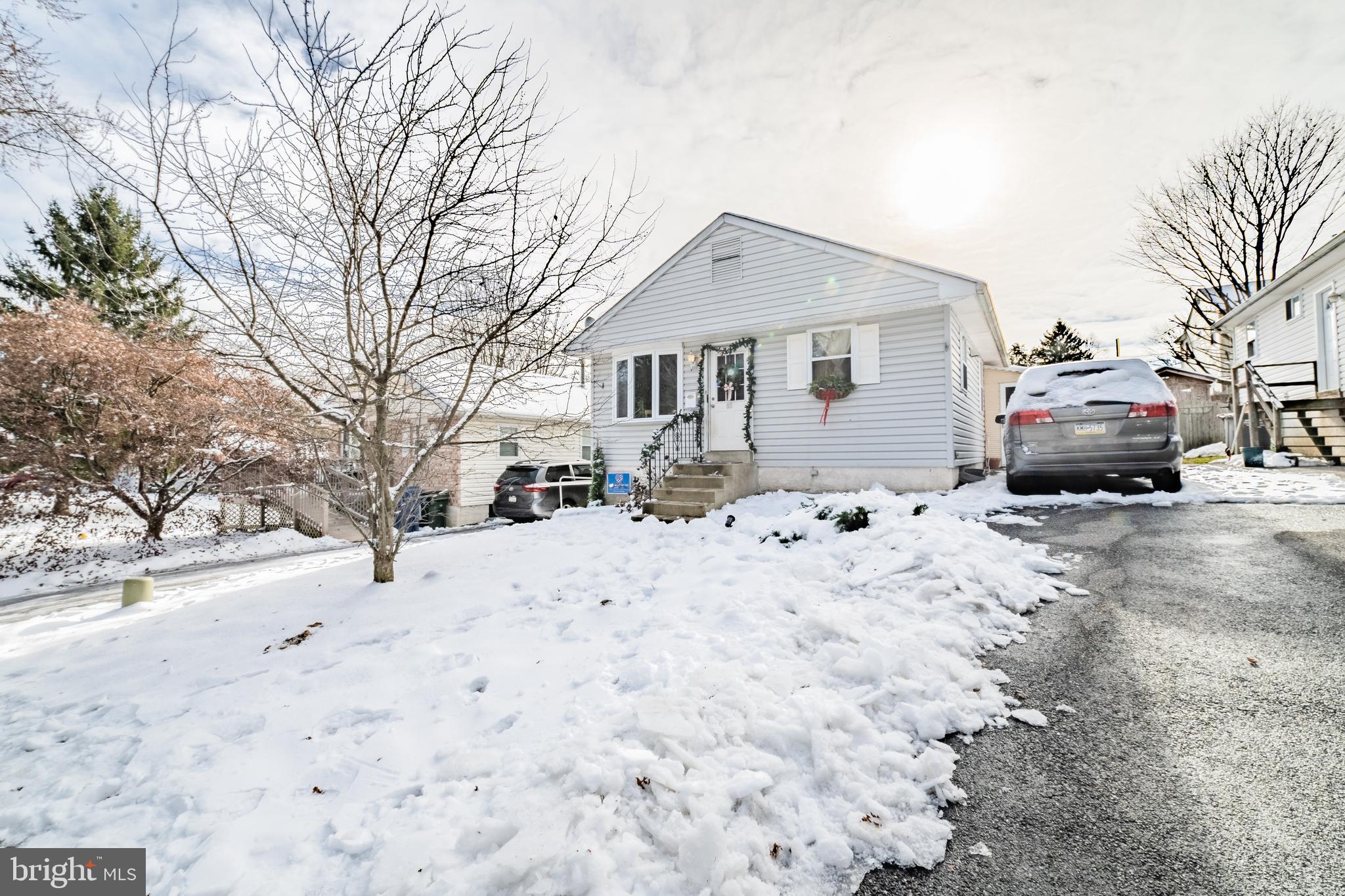 811 Pine Road Wallingford, PA 19086 - Photo 1 of 41 a front view of a house with a yard covered in snow