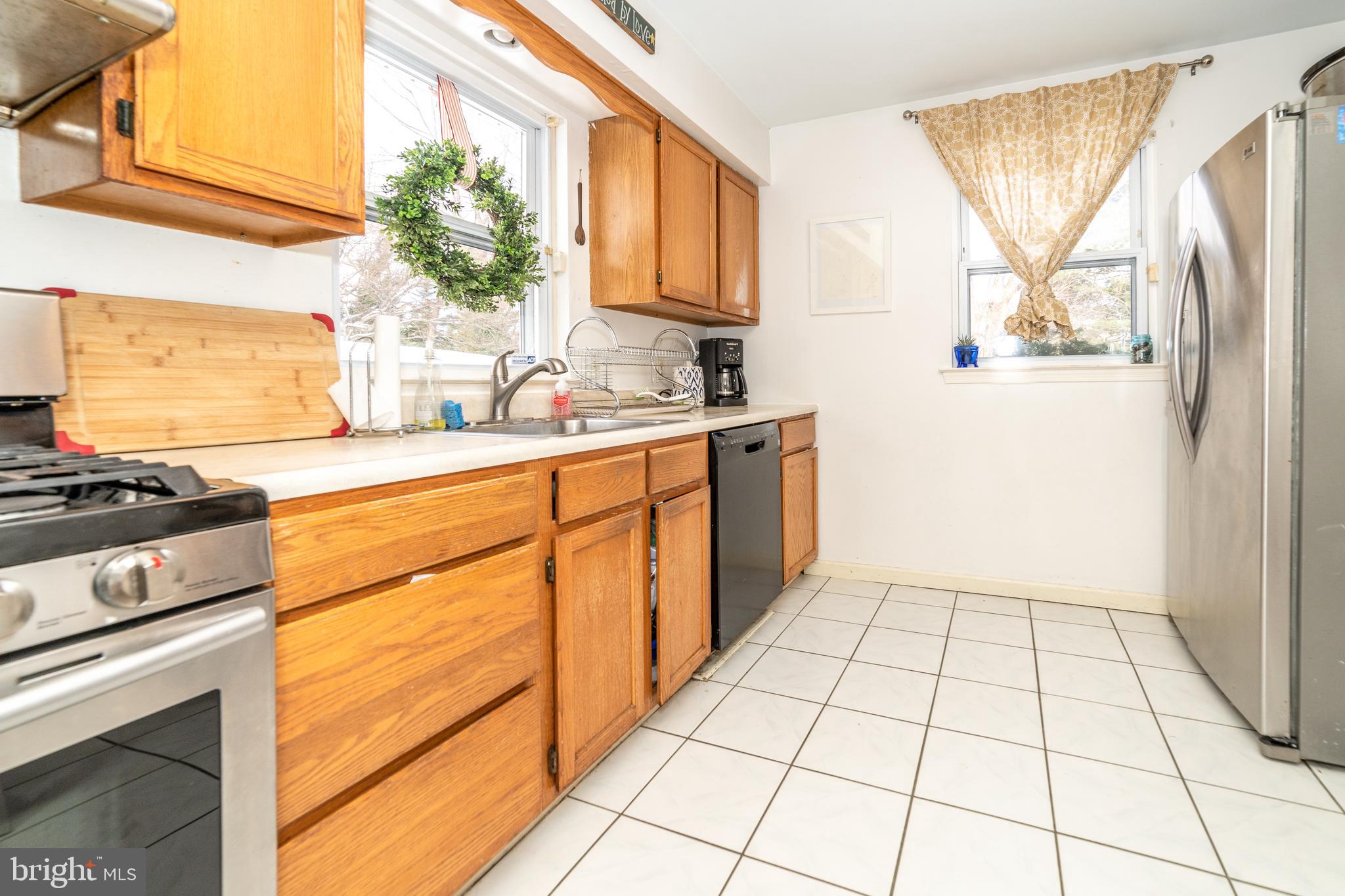 811 Pine Road Wallingford, PA 19086 - Photo 11 of 41 a kitchen with a stove a sink and a refrigerator