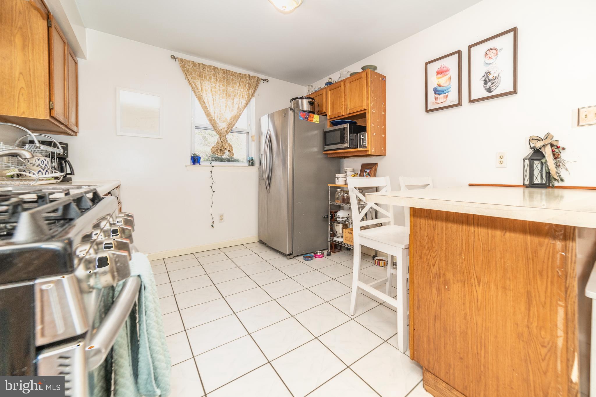 811 Pine Road Wallingford, PA 19086 - Photo 12 of 41 a view of a kitchen with fridge and workspace