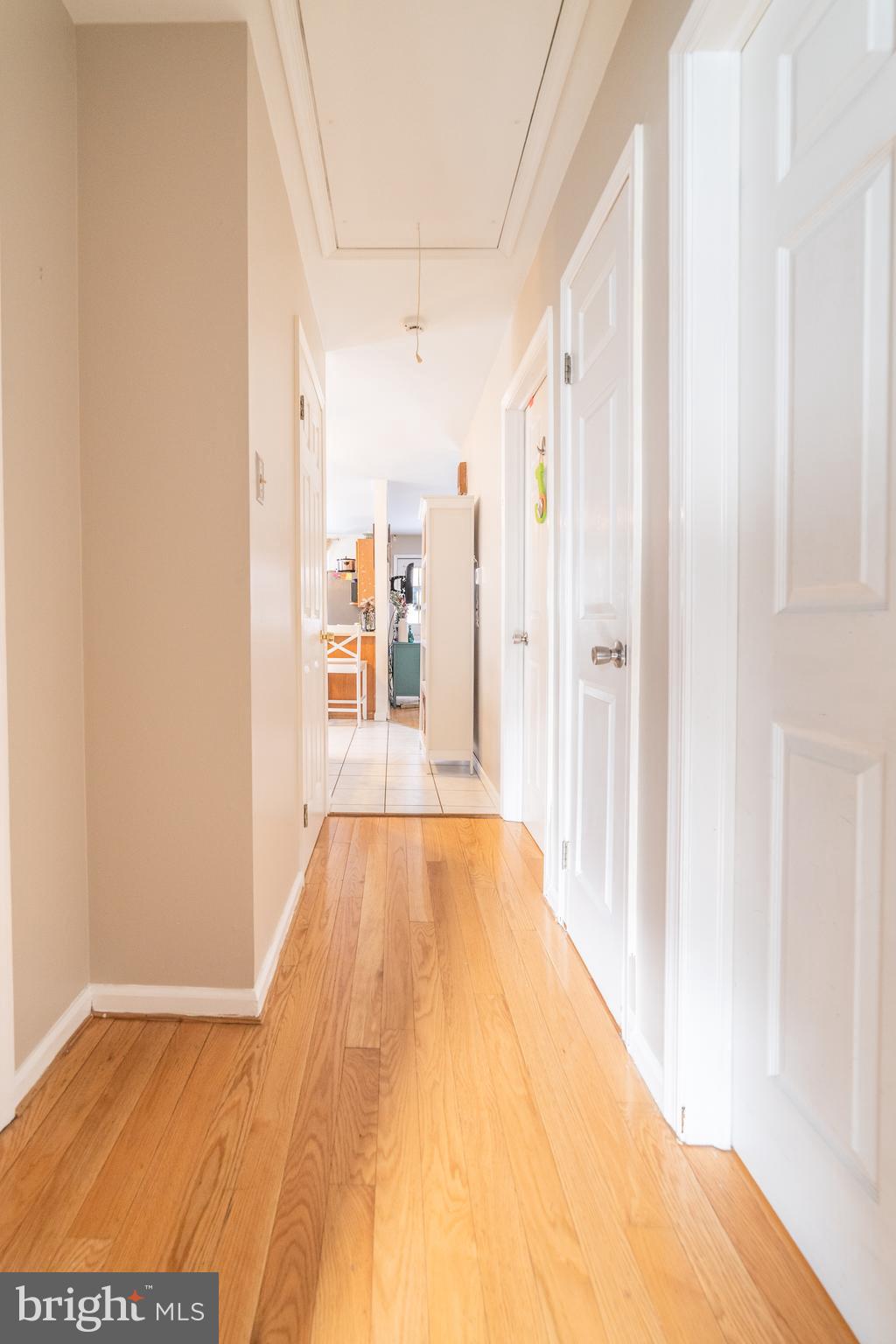 811 Pine Road Wallingford, PA 19086 - Photo 13 of 41 a view of a hallway with wooden floor and a bathroom