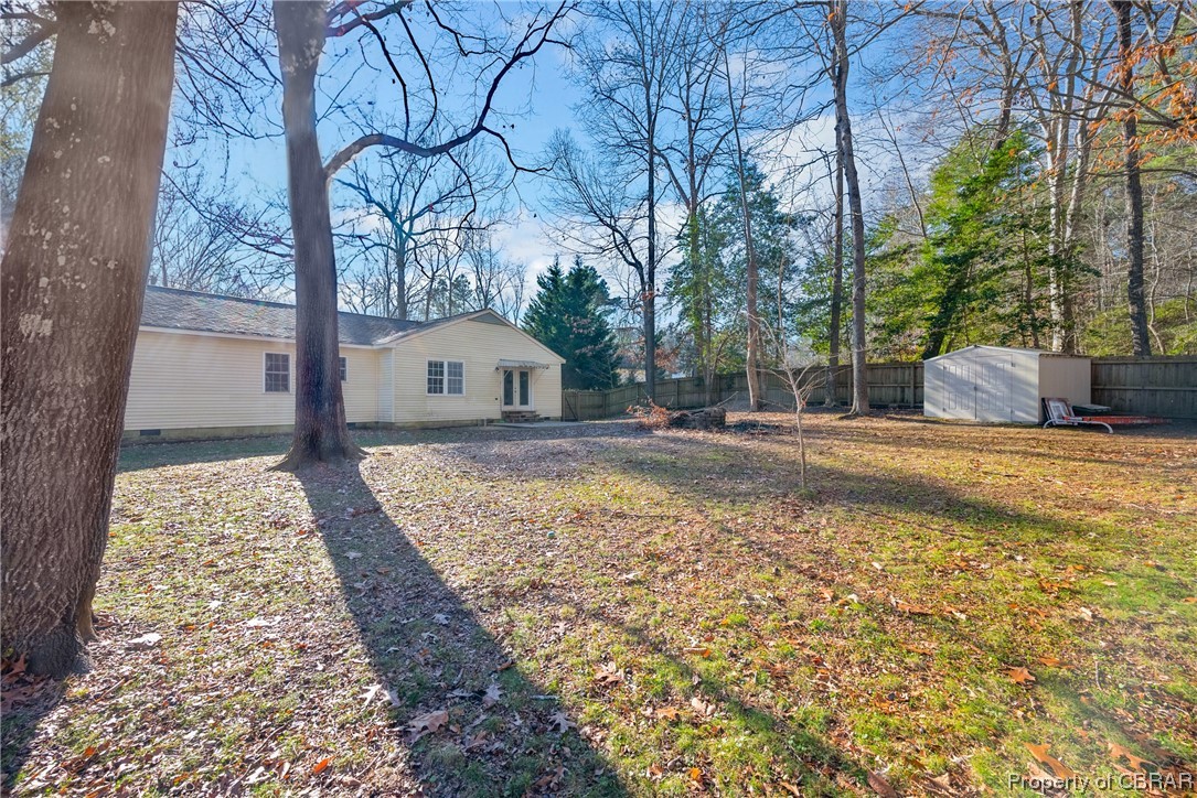 7635 Forbes Road Gloucester, VA 23061 - Photo 25 of 45 View of yard with a storage unit