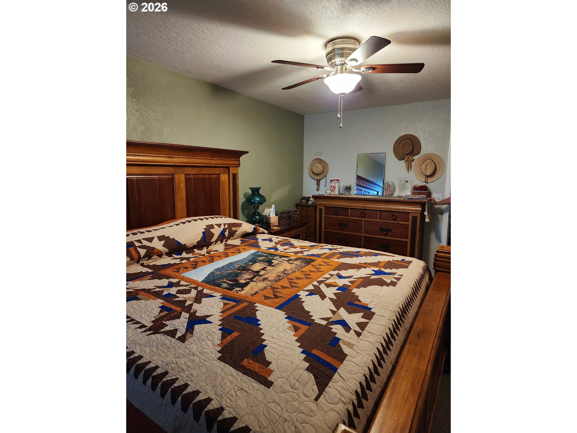 795 E Street Riddle, OR 97469 - Photo 18 of 40 a bedroom with a bed and a chandelier