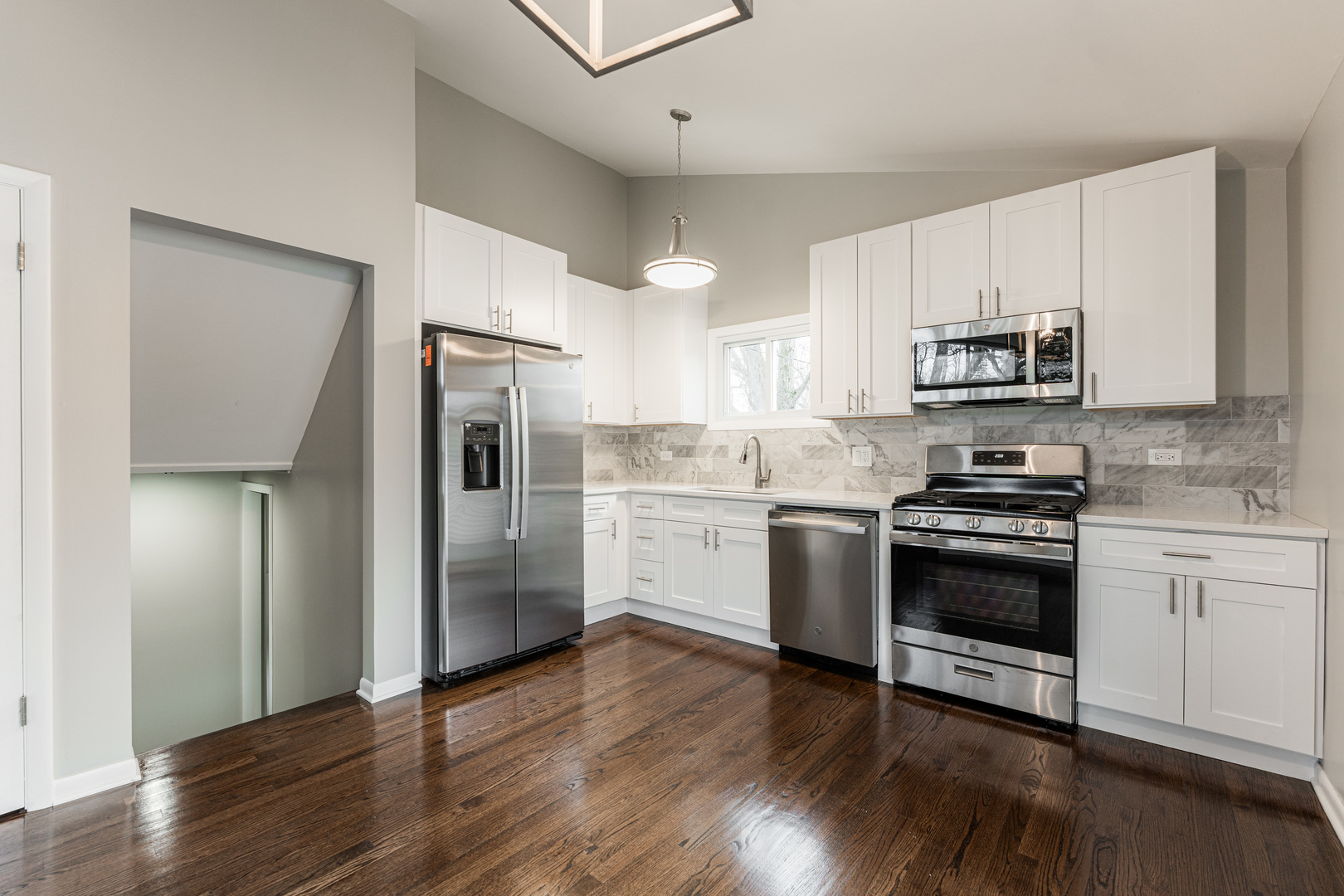 320 South Finley Road Lombard, IL 60148 - Photo 8 of 29 a kitchen with granite countertop a refrigerator stove and wooden floor