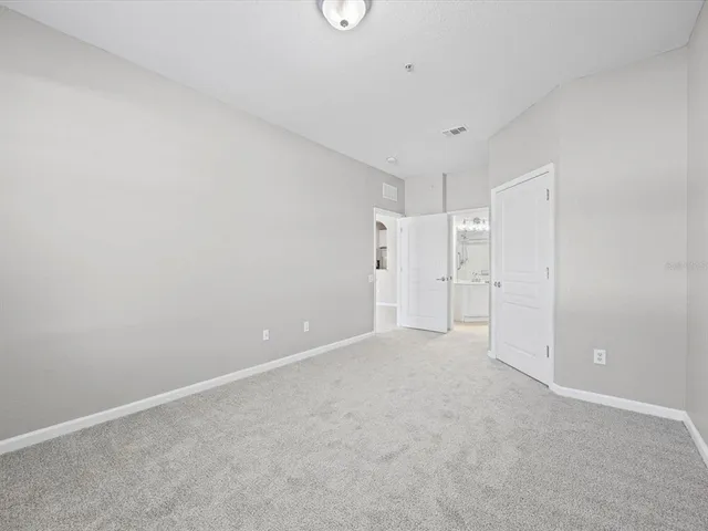 a bathroom with a sink a toilet and a large mirror
