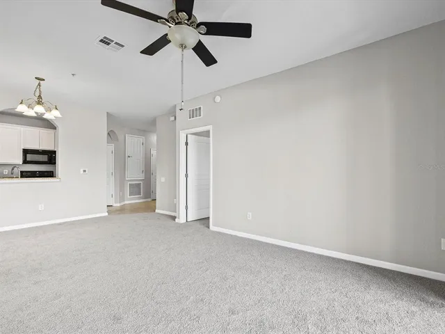 an empty room with a empty space and a ceiling fan