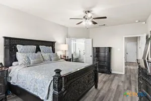 a dining hall with stainless steel appliances granite countertop a stove oven a dining table and chairs with wooden floor