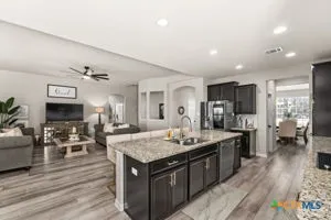 a kitchen with sink cabinets and appliances