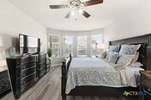 a bathroom with a granite countertop shower a sink and a mirror