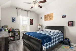 a bedroom with a bed and window