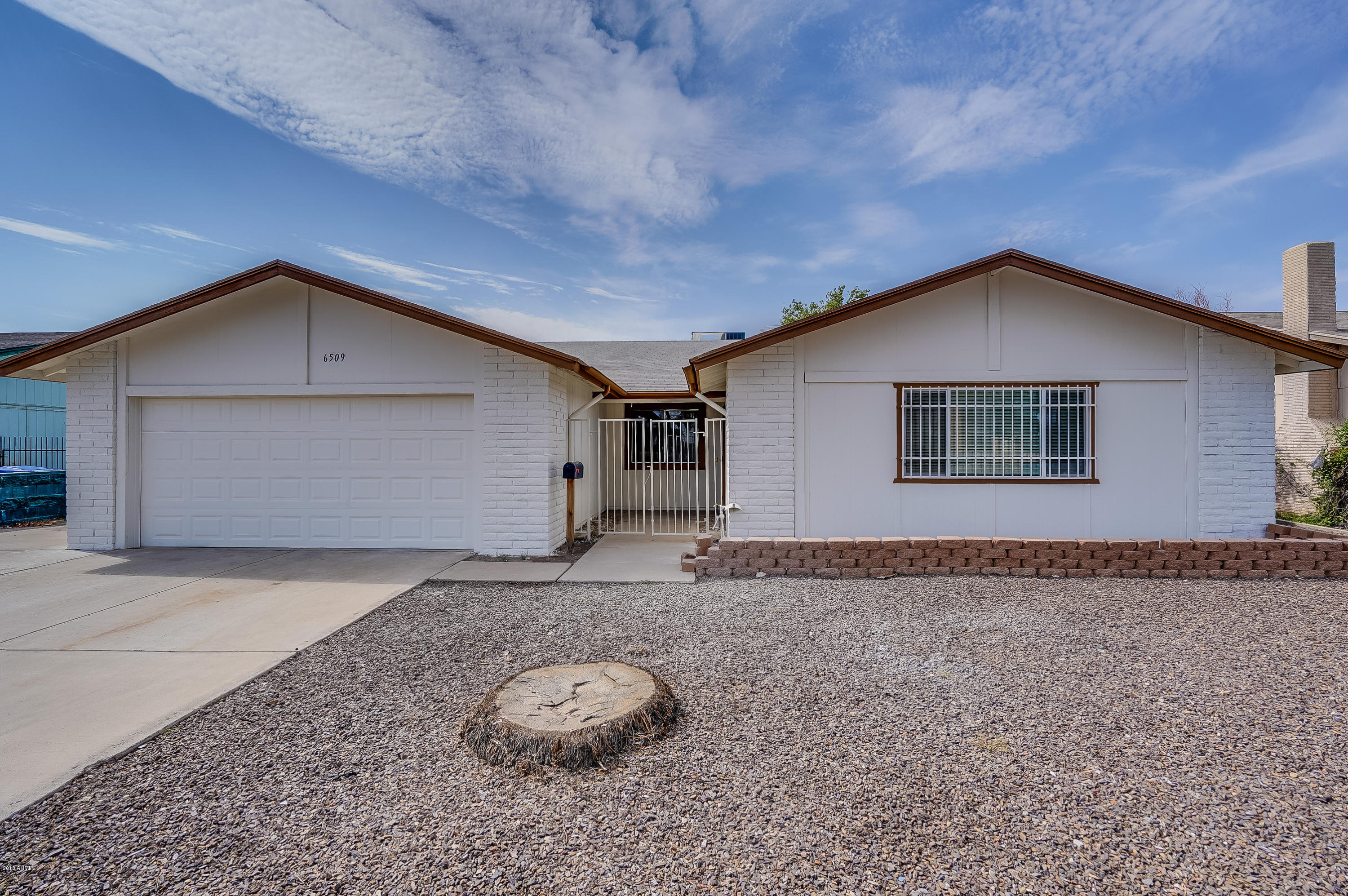 6509 West Camelback Road Phoenix, AZ 85033 - Photo 1 of 25 a front view of a house with a yard